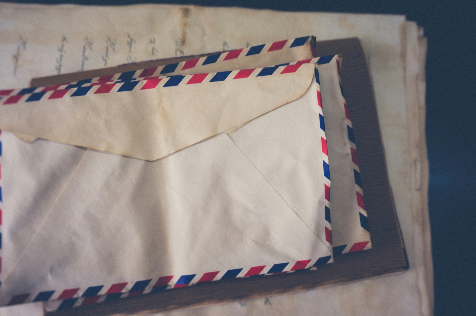Opened envelope and letter resting on a wooden shop counter