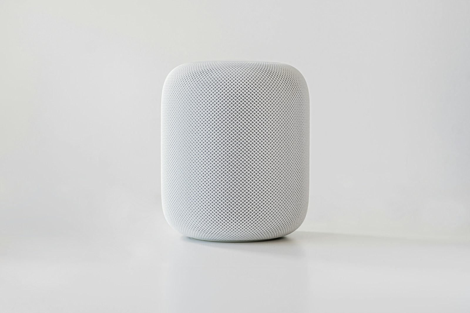 White smart speaker on a neutral background