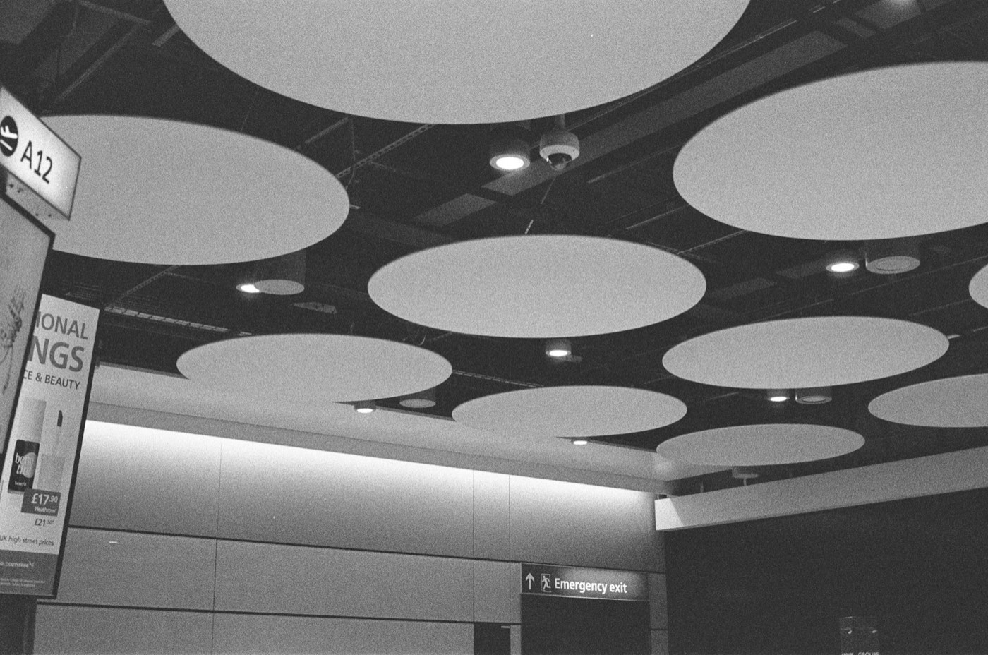 Retail store ceiling with mounted speaker visible above the sales floor