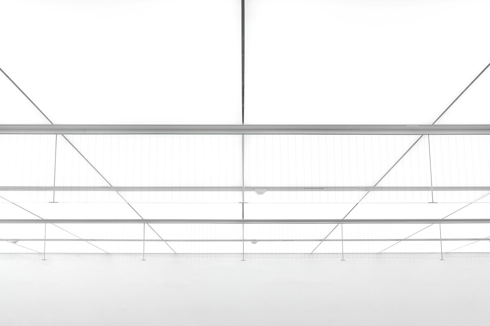 Empty retail store interior with high ceiling and overhead architecture