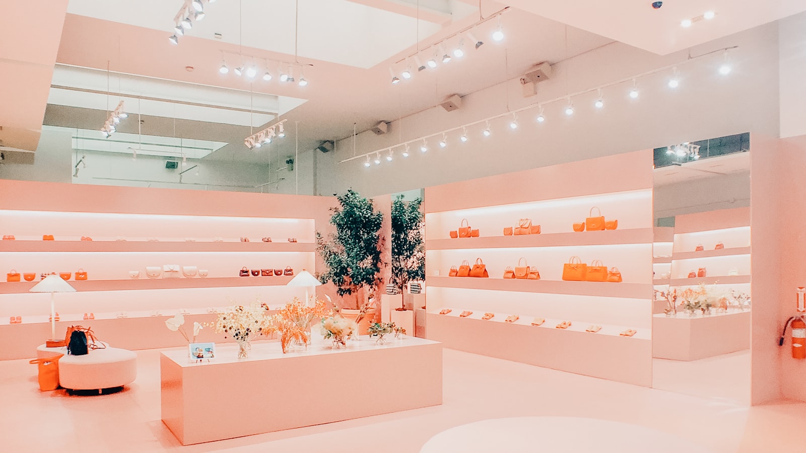 A retail store interior lined with white display shelves