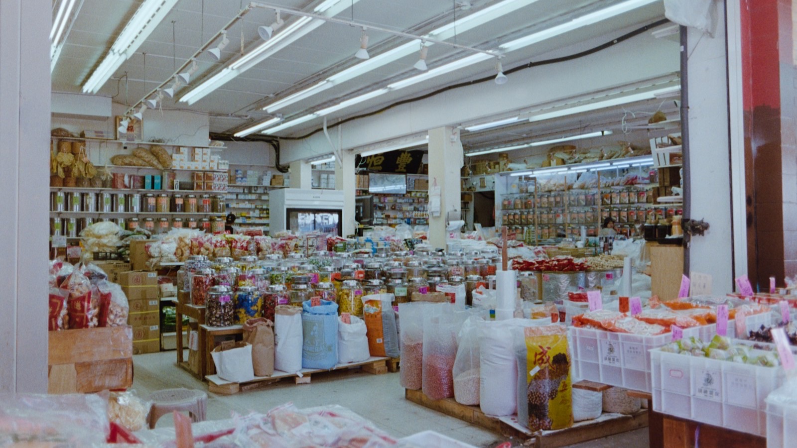 A busy, well-stocked grocery store interior packed with goods