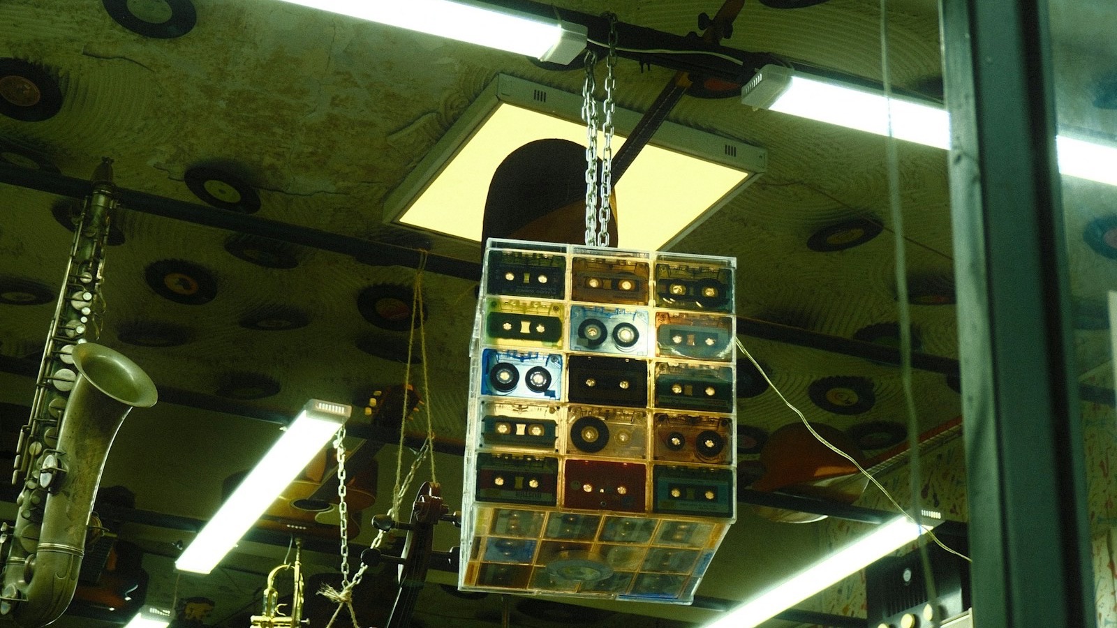 Record display hanging in a shop alongside musical instruments